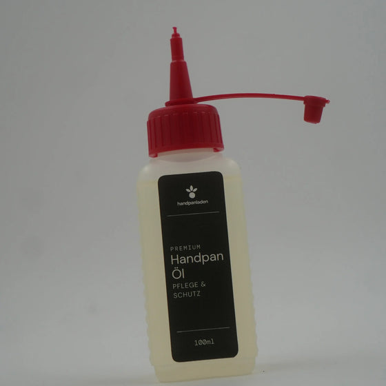 Handpan Öl 100 ml, Flasche leicht gedreht mit schwarzem Etikett – handpanladen